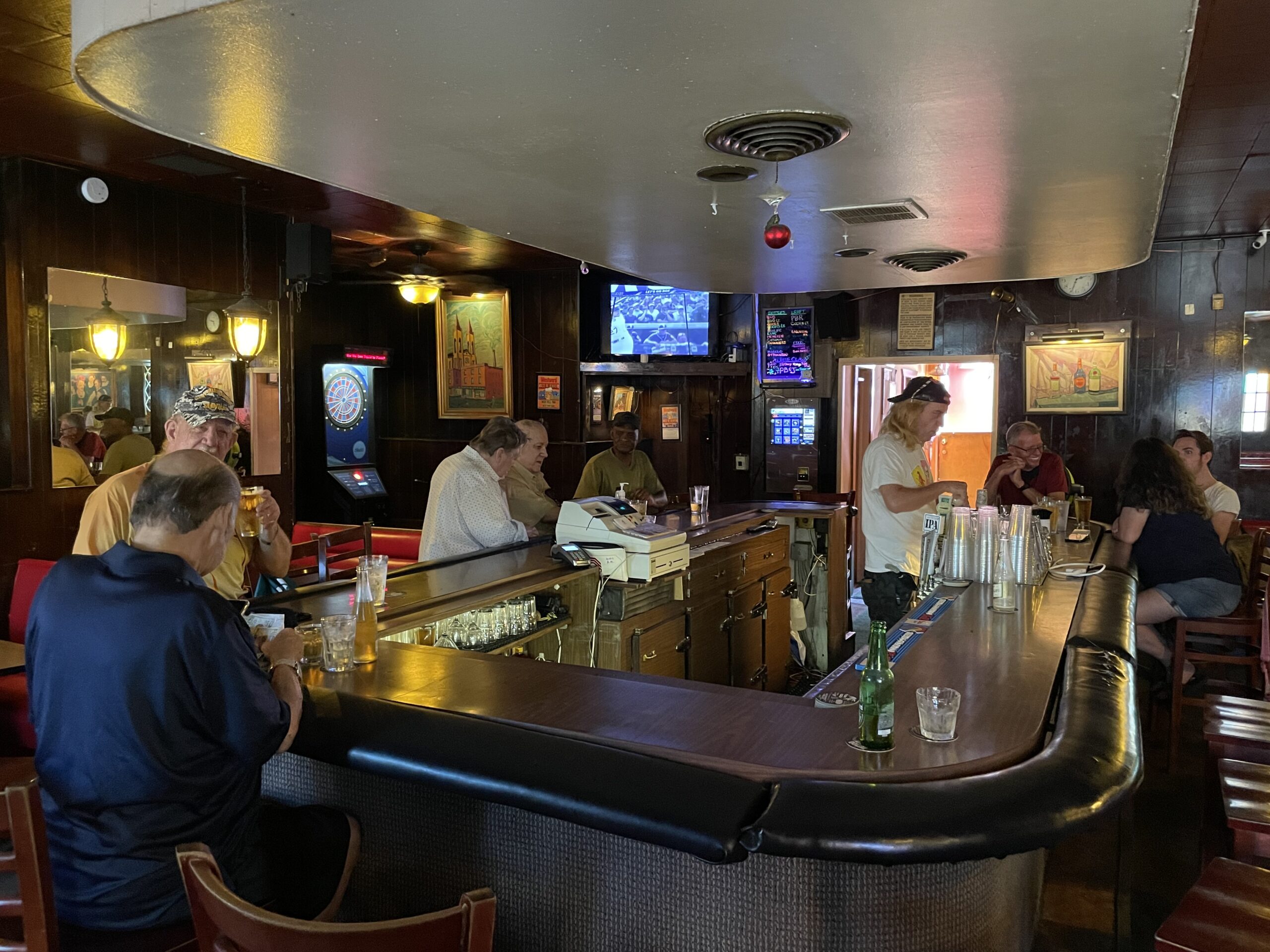 Patrons gathered around the wood-paneled bar at Nob Hill Inn